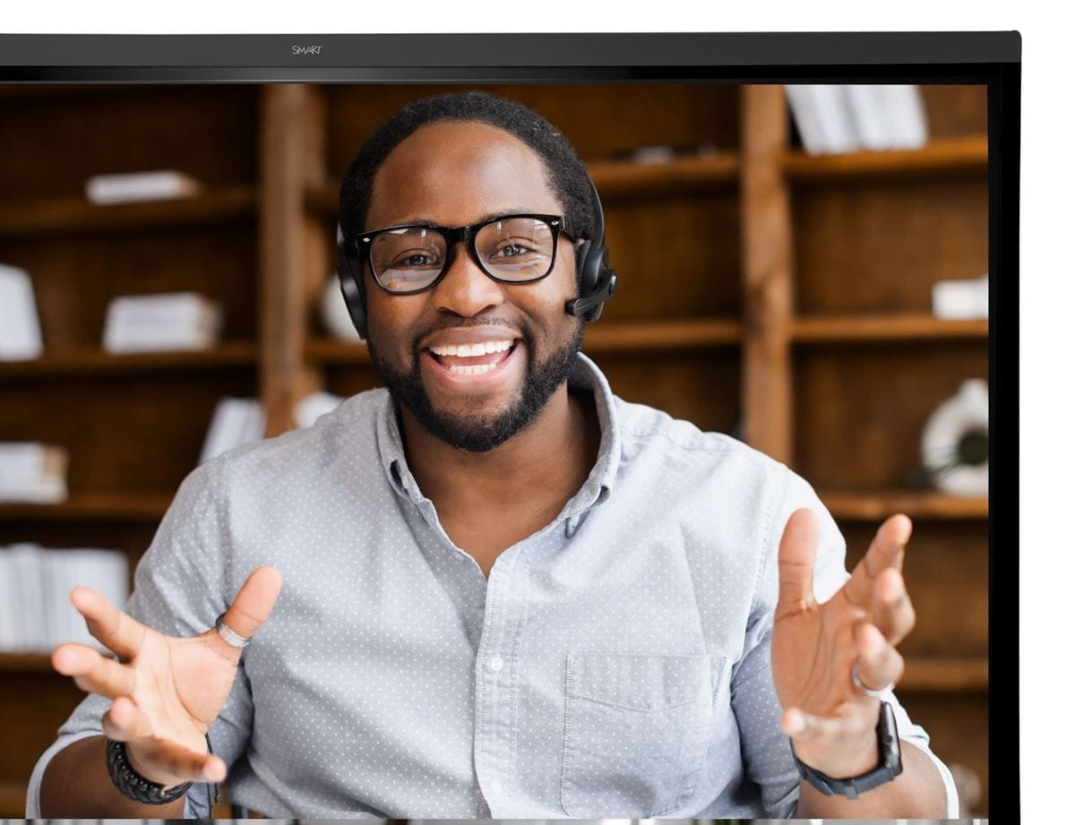 Professional engaging with remote teams on a SMART Board, highlighting seamless integration with collaboration tools like Microsoft Teams, Zoom, and Google Meet.