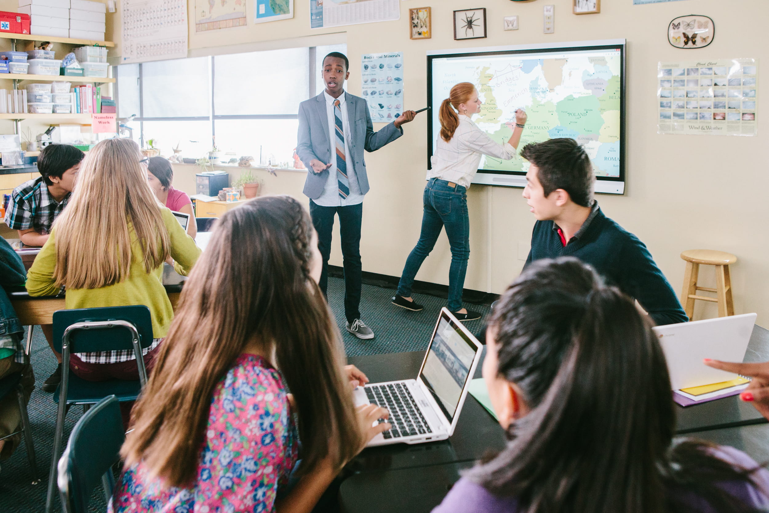 Two students presenting their assignment in front of the classroom