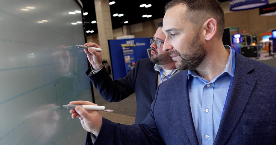 Image of a businessman trying out the QX Pro SMART Board.