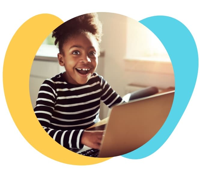 Smiling young student using a laptop with Lumio educational software.