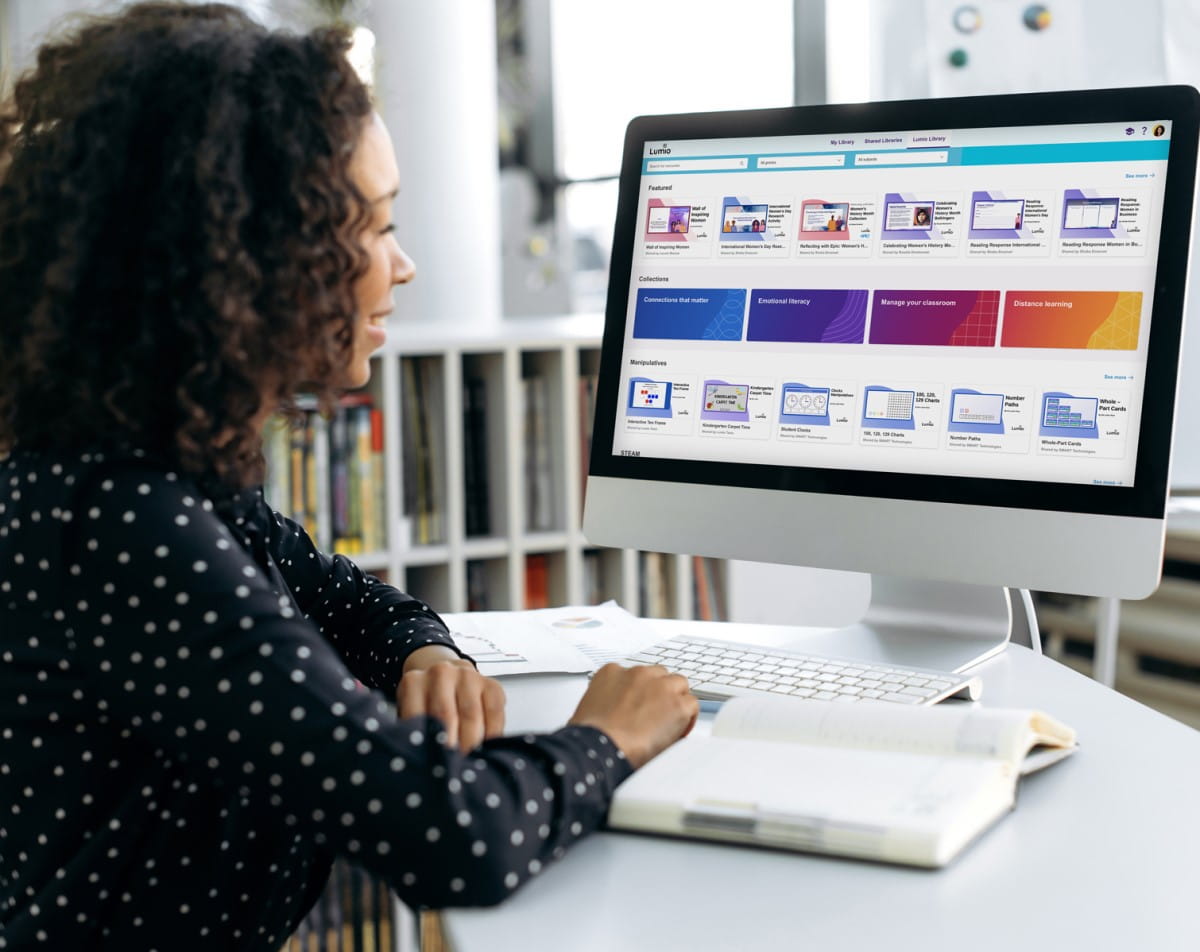 Educator exploring the Lumio digital library on a desktop computer, with collections on Connections that matter, Emotional literacy, and more displayed on screen.