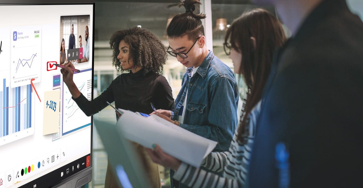 Diverse team collaborating using a SMART Board interactive display in a Crestron connected environment.
