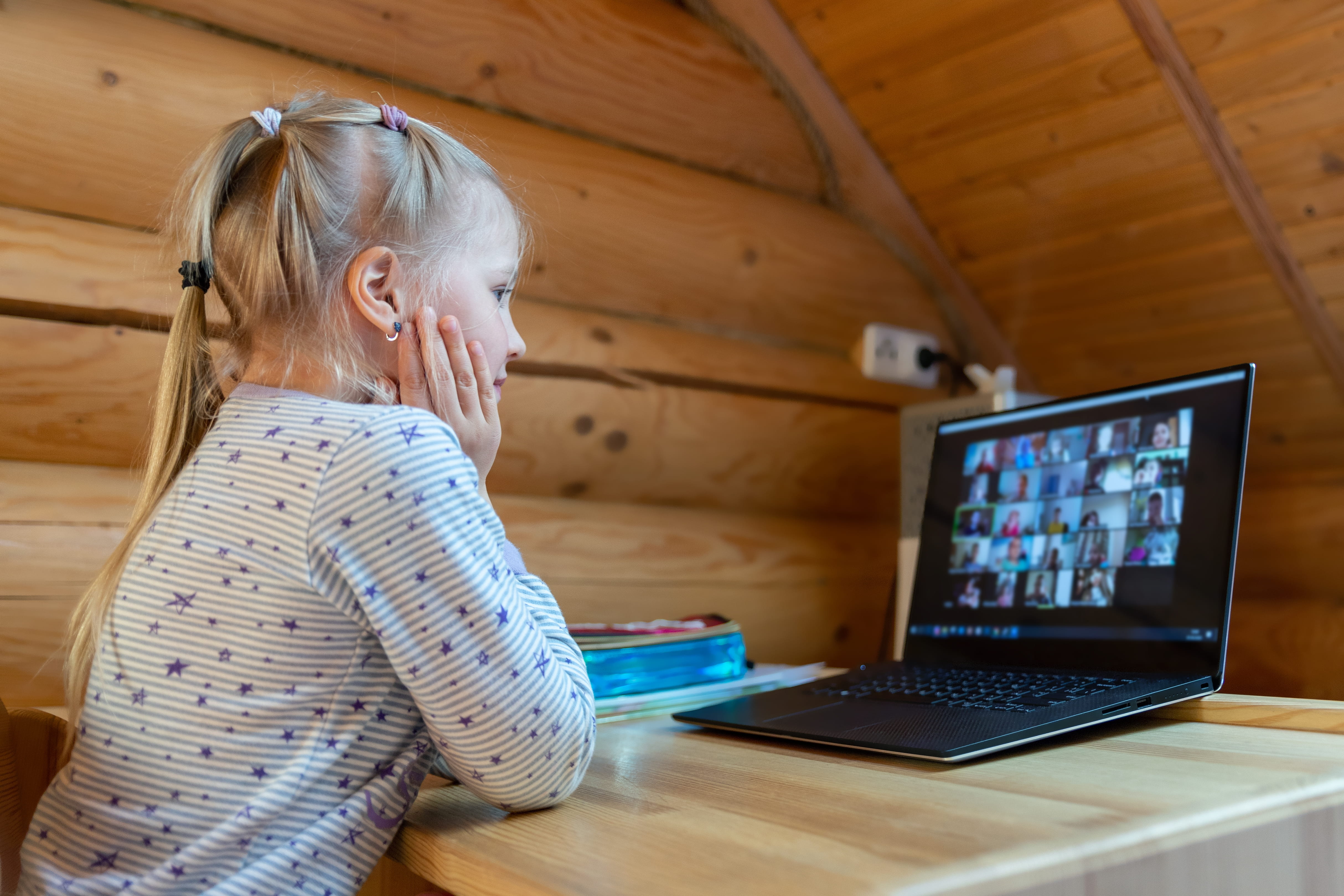 A student interacts with her classmates during a remote learning lesson.