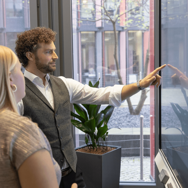 Two professionals interacting with a SMART Interactive Display for business.