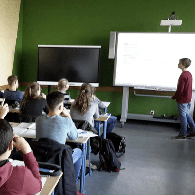 A teacher presenting to a room full of students