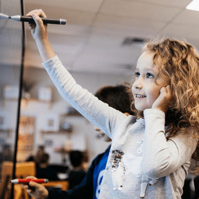 Young student using a SMART board 