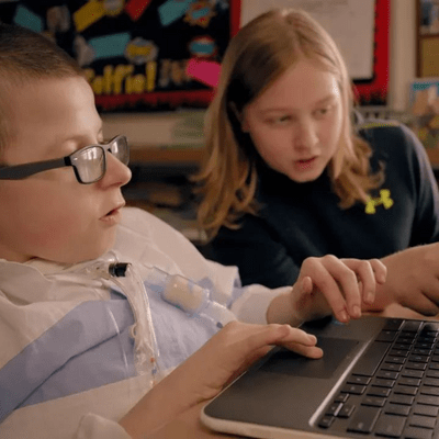 Two students using the laptop